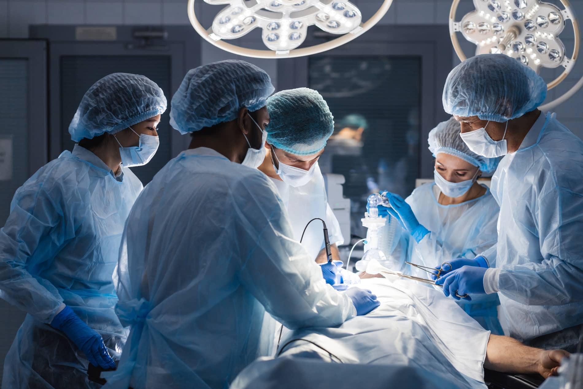 Fully gowned medical professionals in a surgery