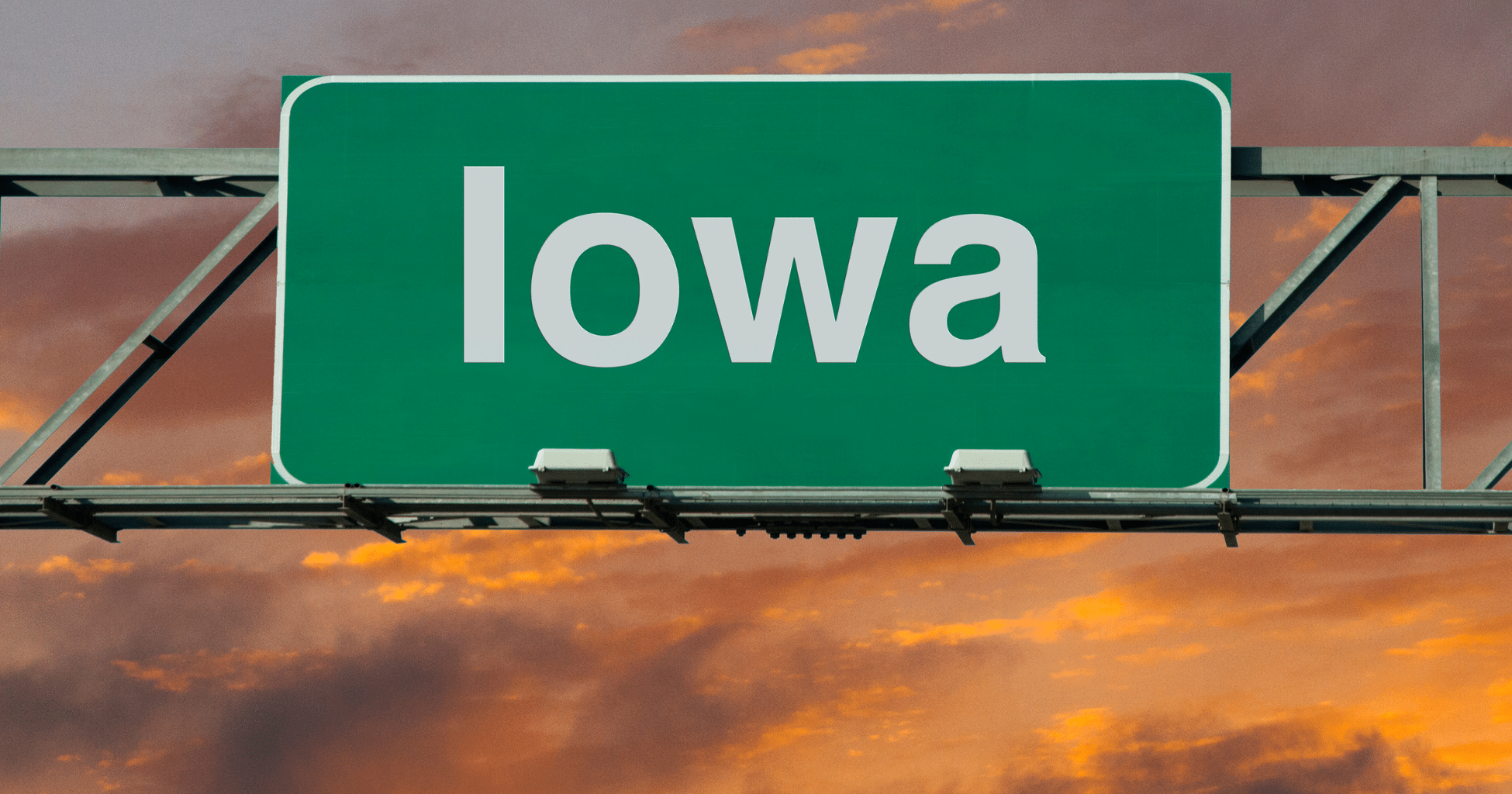 A green road sign indicating that you have arrived to the state of IOWA